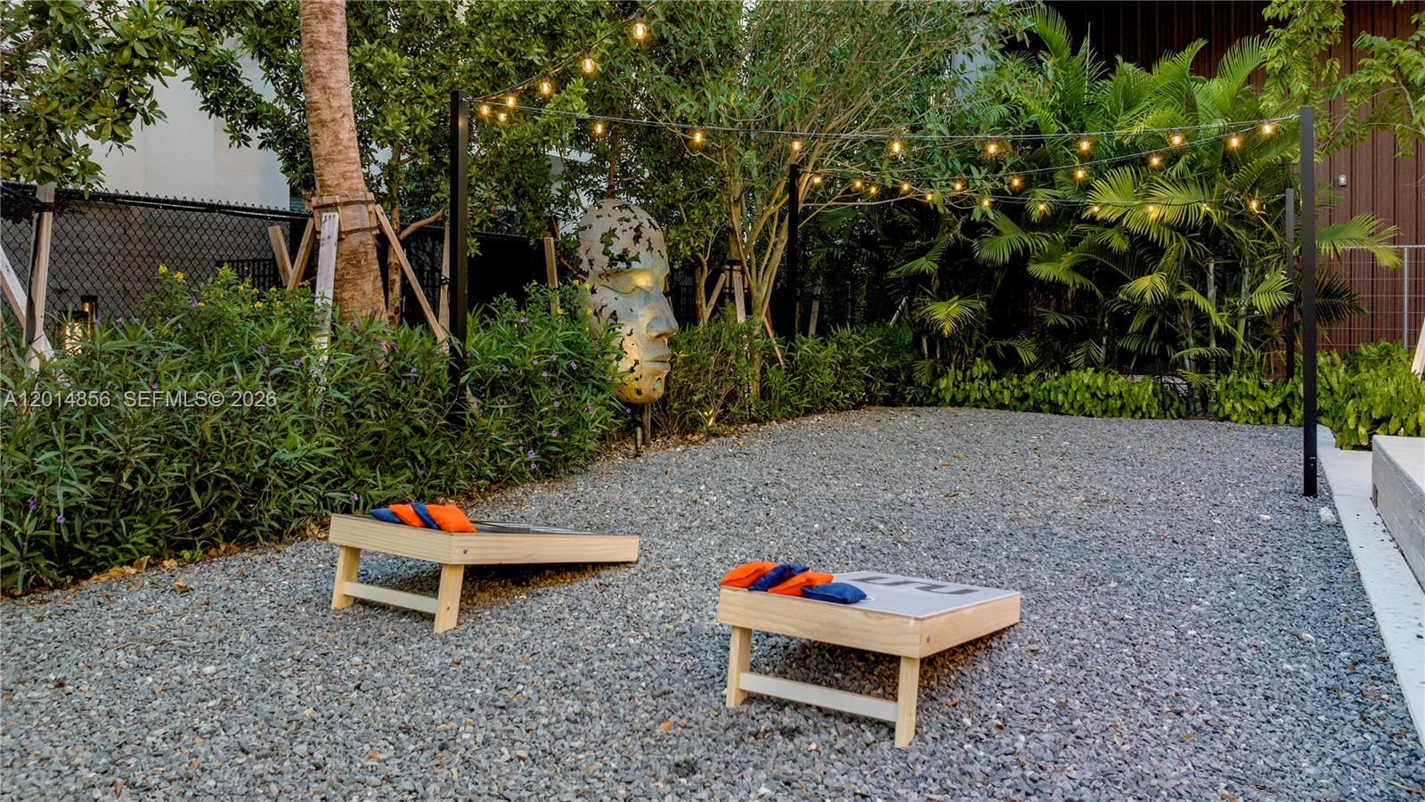 6970 Southwest 40th Street, Unit 228 Miami, FL 33155 - Photo 12 of 22 a backyard of a house with table and chairs