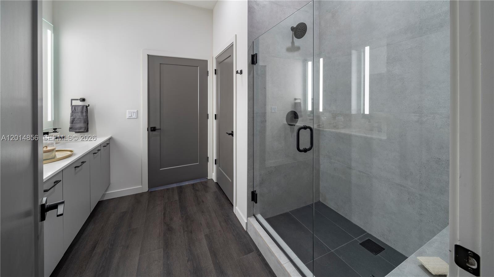 6970 Southwest 40th Street, Unit 228 Miami, FL 33155 - Photo 18 of 22 a bathroom with a double vanity sink a toilet and shower