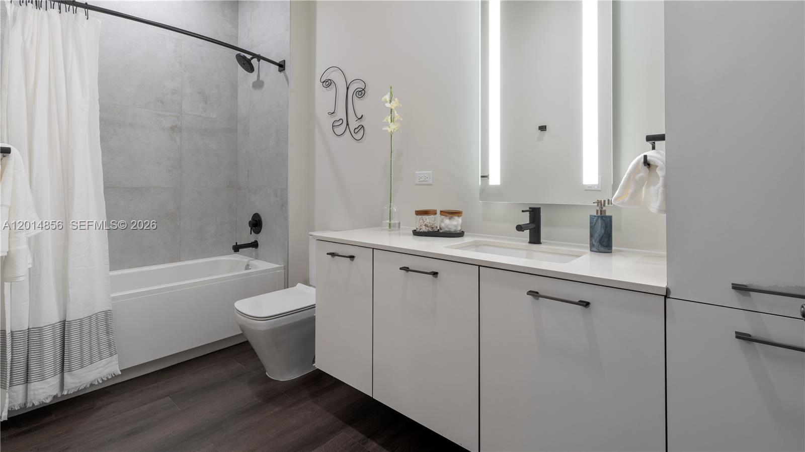6970 Southwest 40th Street, Unit 228 Miami, FL 33155 - Photo 20 of 22 a bathroom with a double vanity sink toilet and shower