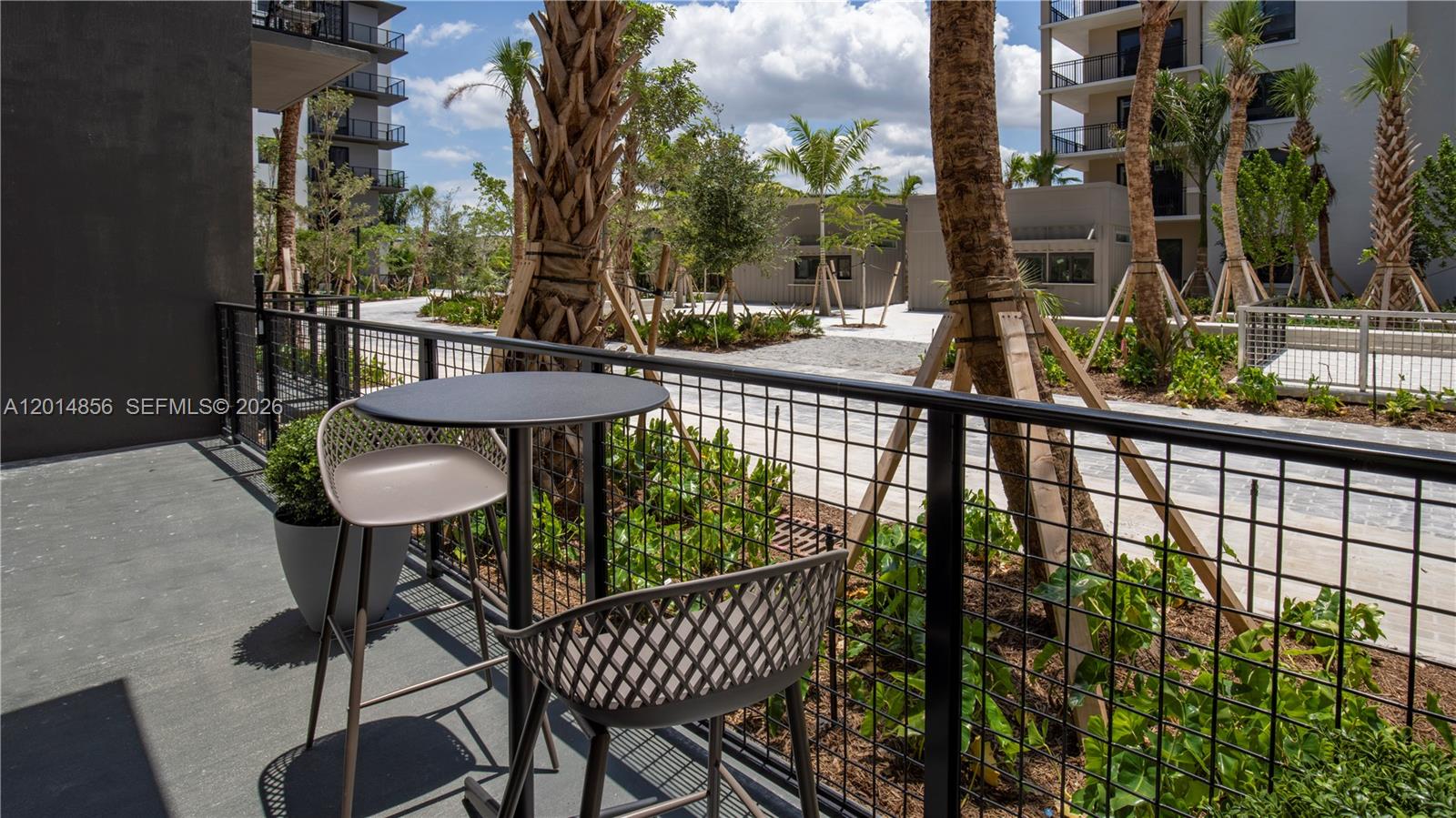 6970 Southwest 40th Street, Unit 228 Miami, FL 33155 - Photo 22 of 22 a view of a balcony with chairs and wooden fence