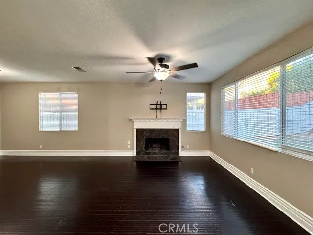 a living room with fireplace furniture and a large window