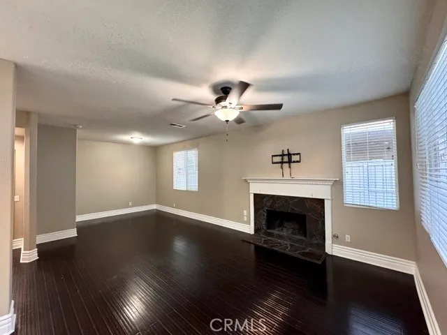 a living room with wooden floors and a fireplace