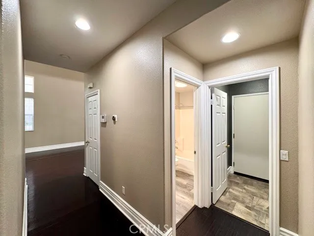 a bathroom with a toilet a sink a mirror and a bathtub