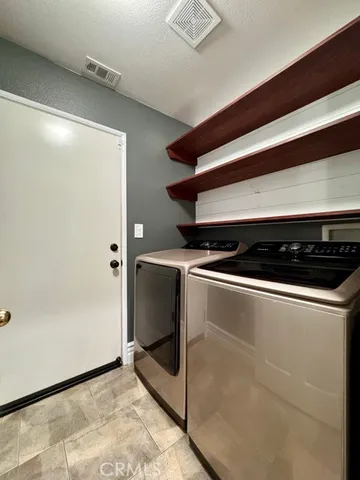 a view of staircase with wooden floor and white walls