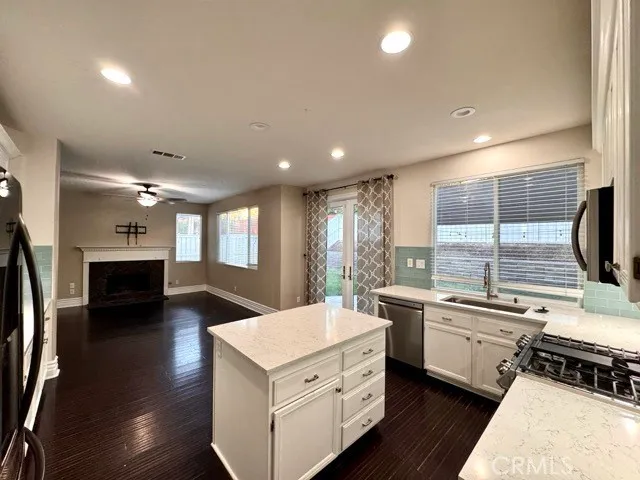 a kitchen with a sink stainless steel appliances and window