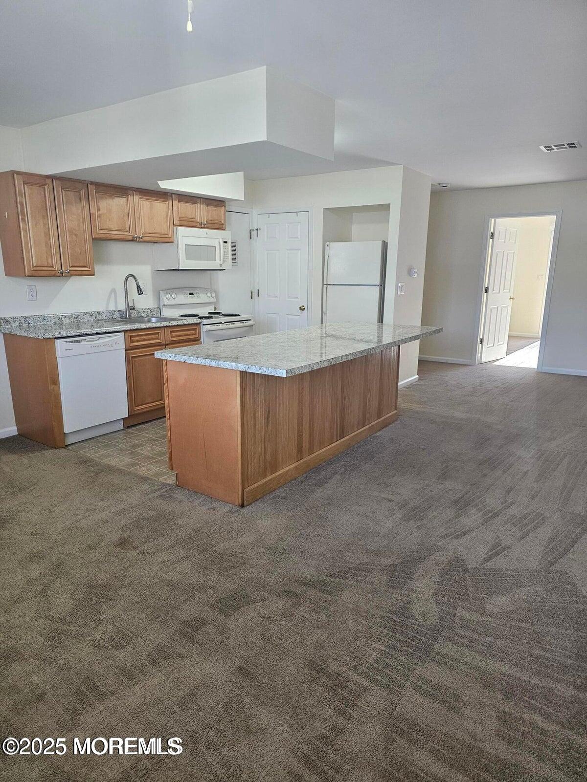 290 Highway 9, Unit B10 Barnegat, NJ 08005 - Photo 2 of 5 a large kitchen with kitchen island granite countertop a sink and a granite counter tops