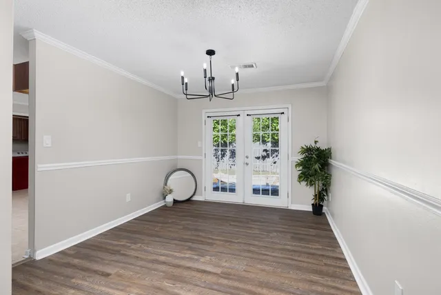 a view of a room with wooden floor and windows