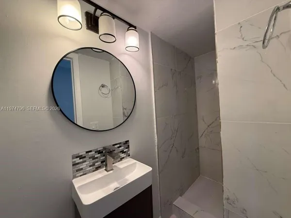 a bathroom with a sink toilet and a mirror