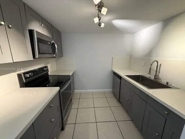 a kitchen that has a sink and a stove in it