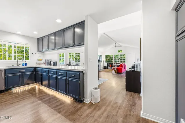 a kitchen with stainless steel appliances wooden cabinets and a stove top oven