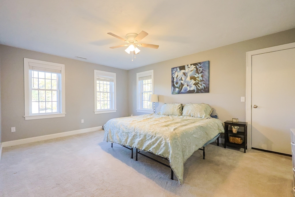 175 A Glenwood Road Rutland, MA 01543 - Photo 15 of 41 a spacious bedroom with a bed and a chandelier