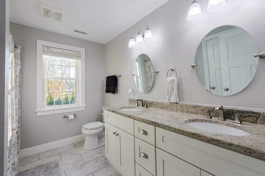 175 A Glenwood Road Rutland, MA 01543 - Photo 17 of 41 a bathroom with a granite countertop double vanity sink a toilet and a mirror