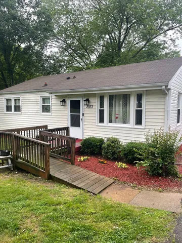 a front view of a house with yard porch and green space