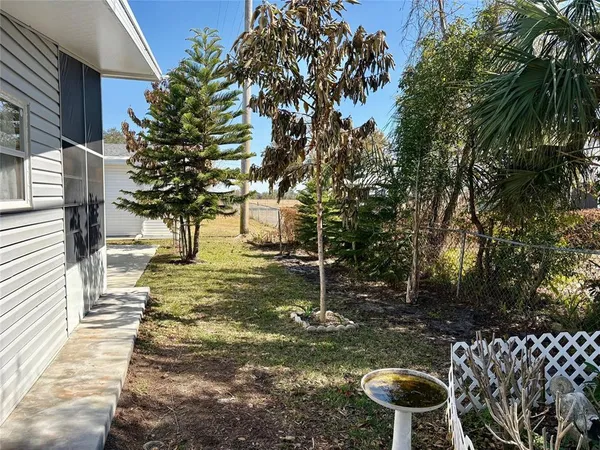 a view of yard with swimming pool and sitting area