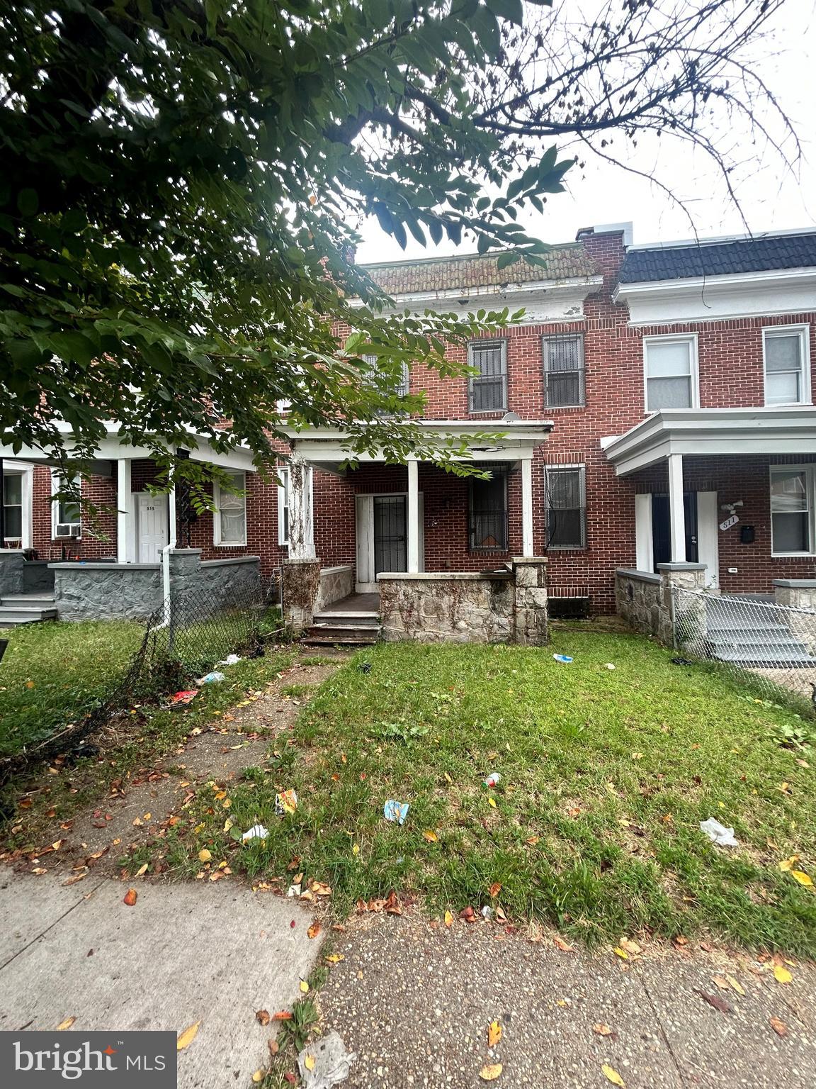 513 Denison Street Baltimore, MD 21229 - Photo 1 of 1 a front view of a house with a yard