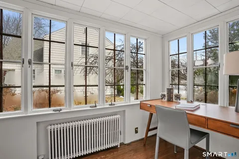 a dining room with wooden floor and a table
