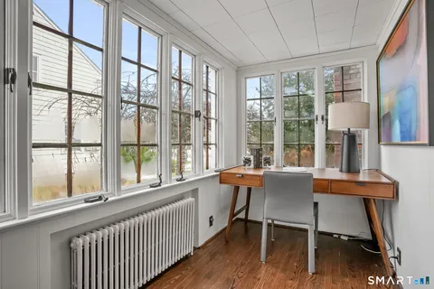 a dining room with furniture and wooden floor