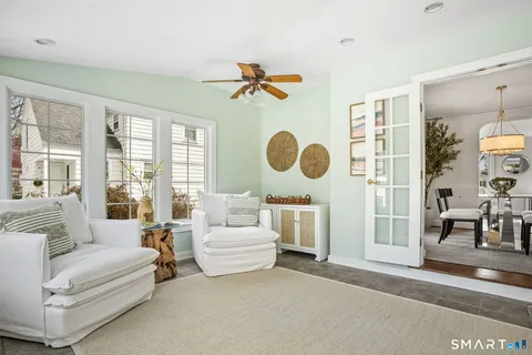 a living room with couches a large window with outer view