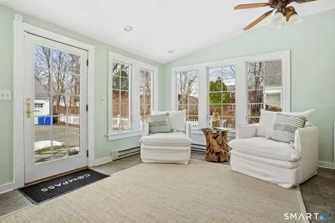 a living room with furniture and large windows