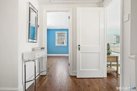 an entryway with wooden floor and cabinet