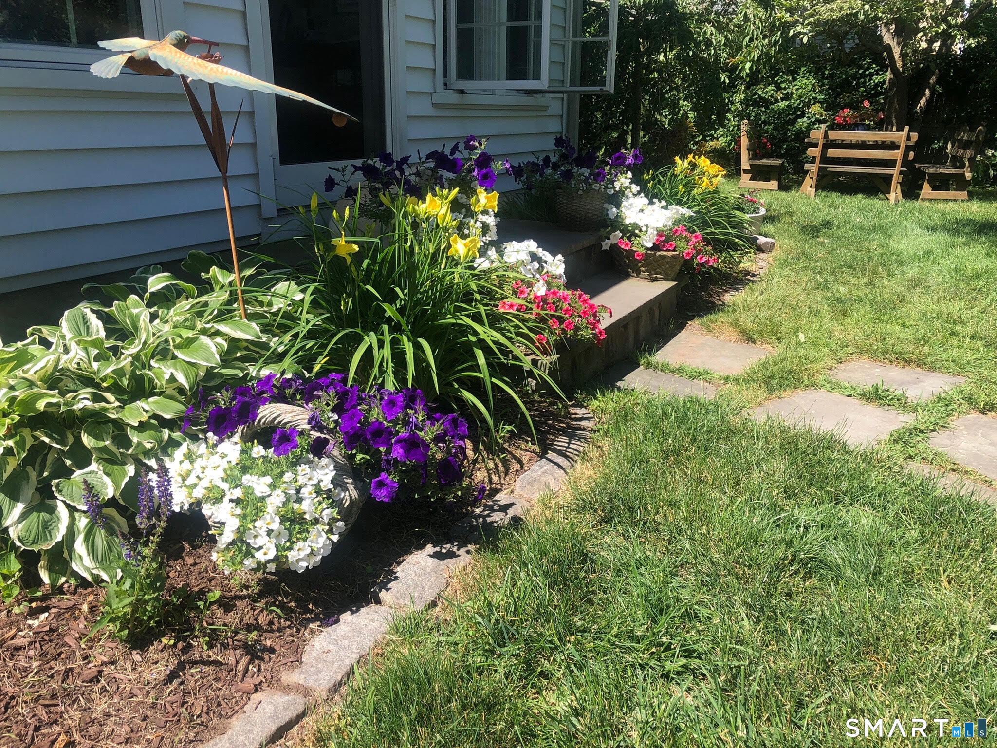 188 Henderson Road Fairfield, CT 06824 - Photo 37 of 38 a bunch of flowers in front of a house