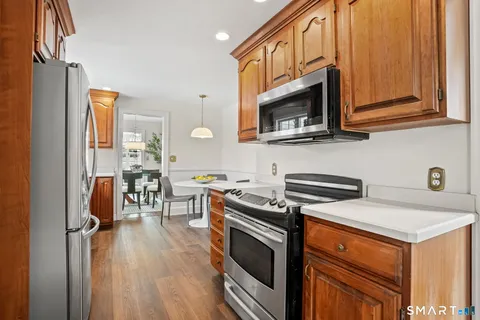 a kitchen with stainless steel appliances a stove a sink and a microwave