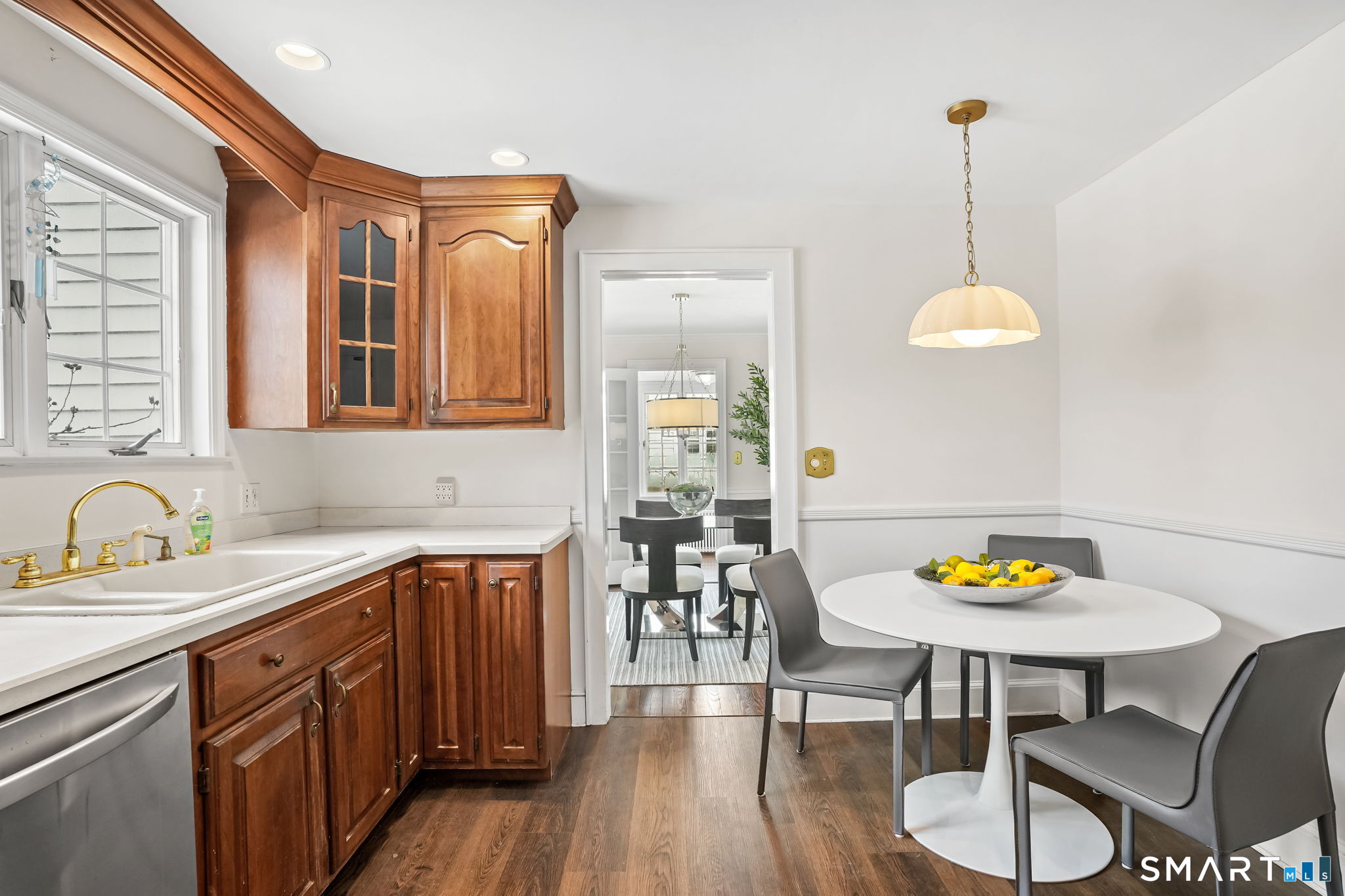 188 Henderson Road Fairfield, CT 06824 - Photo 8 of 38 a kitchen with furniture wooden floor and a chandelier