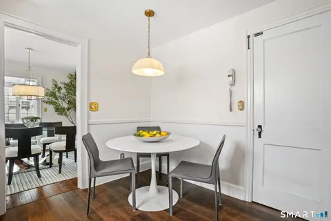a view of a dining room with furniture and wooden floor