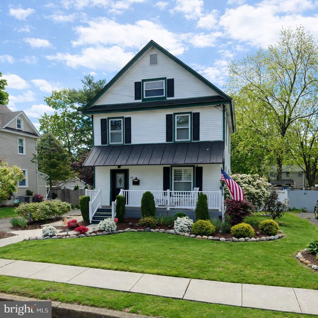 55 Kenton Avenue Pitman, NJ 08071 - Photo 1 of 26 a view of a yard in front of a house with plants and large tree