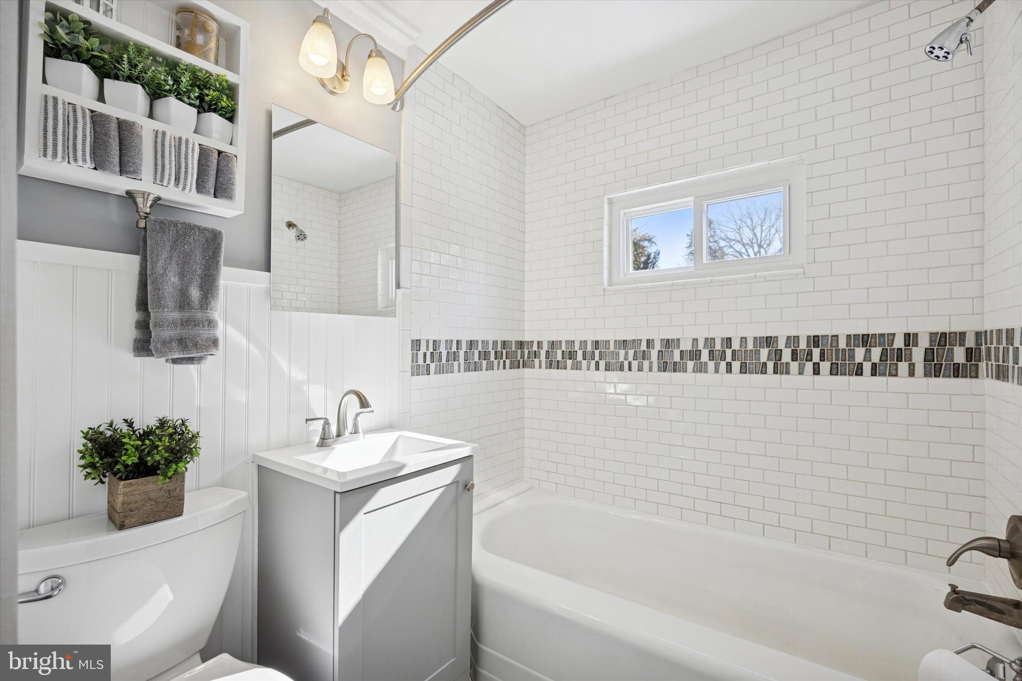 55 Kenton Avenue Pitman, NJ 08071 - Photo 14 of 26 a bathroom with a sink a toilet and shower