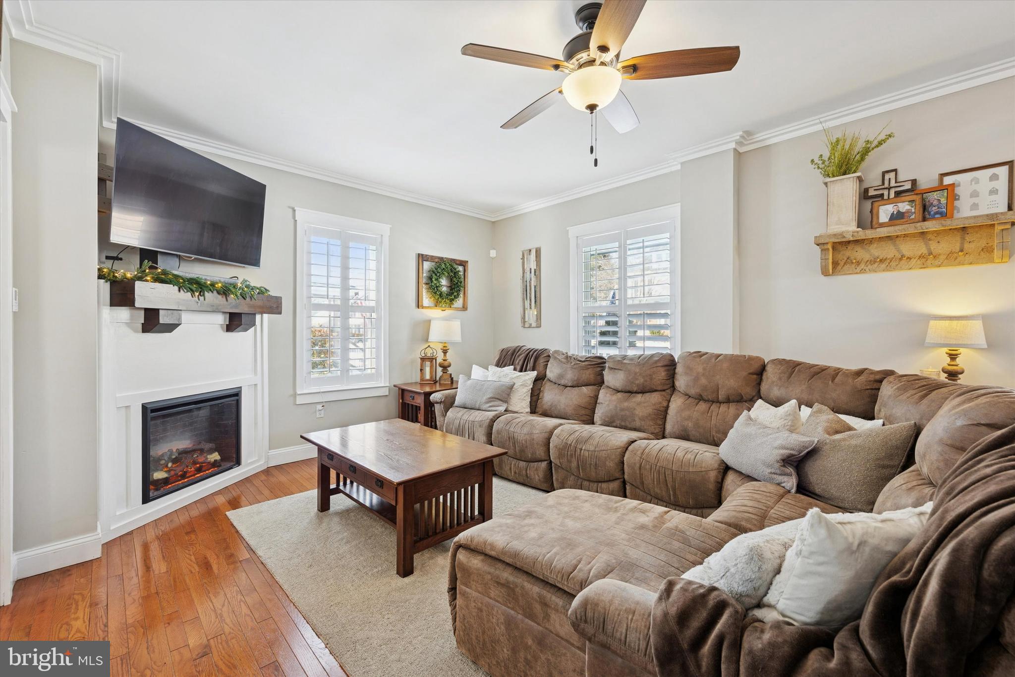 55 Kenton Avenue Pitman, NJ 08071 - Photo 6 of 26 a living room with furniture a flat screen tv and a fireplace