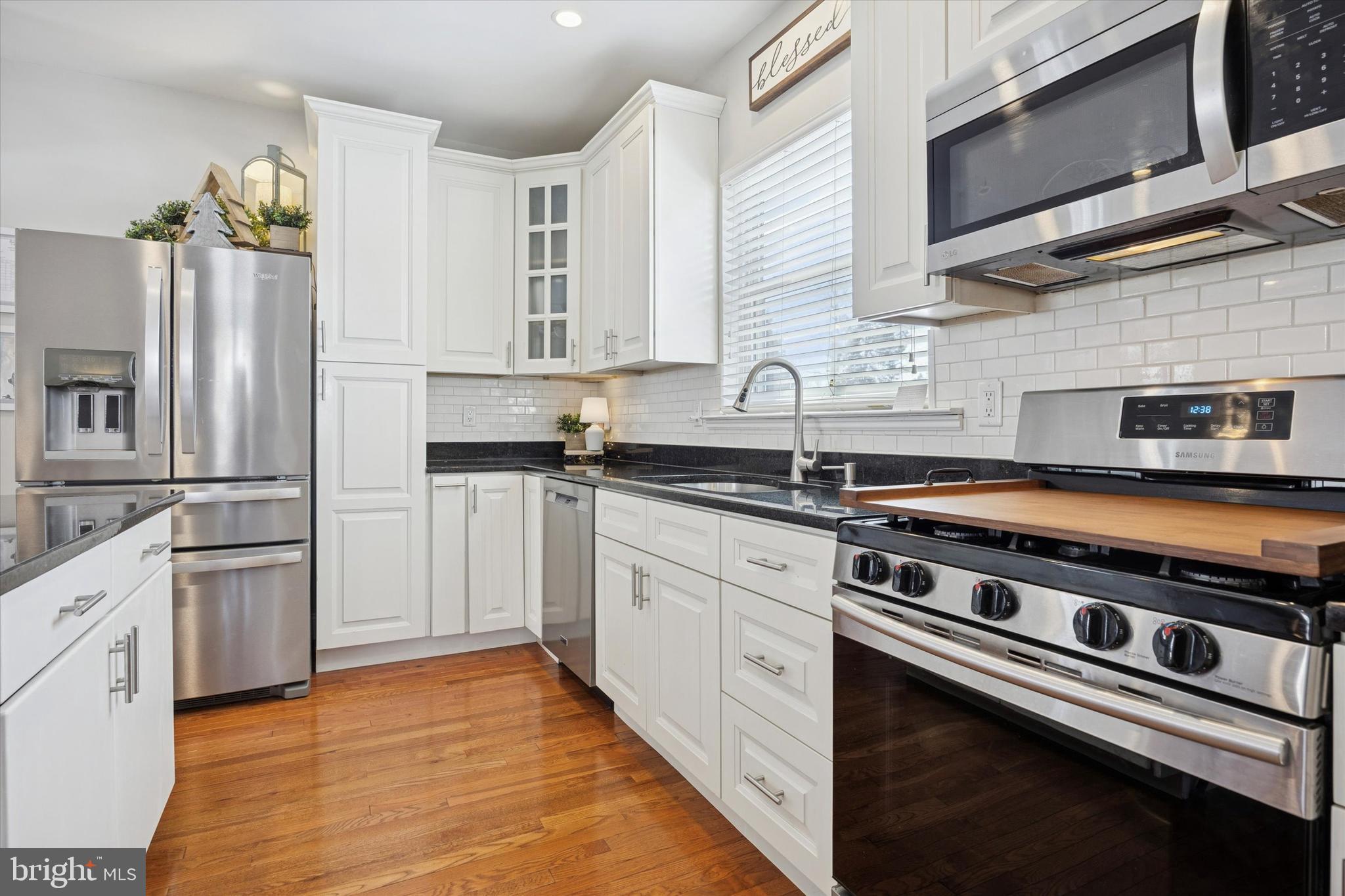 55 Kenton Avenue Pitman, NJ 08071 - Photo 8 of 26 a kitchen with stainless steel appliances a sink stove and refrigerator