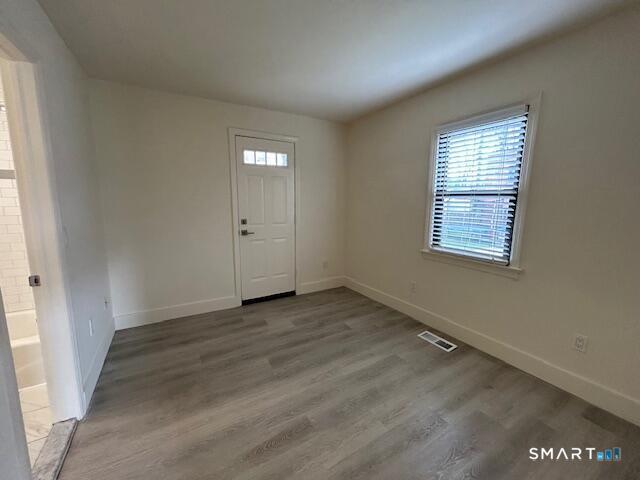 34 Prospect Street, Unit 4M Norwalk, CT 06850 - Photo 3 of 7 an empty room with wooden floor and windows