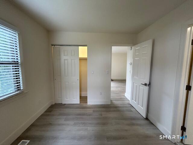34 Prospect Street, Unit 4M Norwalk, CT 06850 - Photo 6 of 7 an empty room with wooden floor and windows