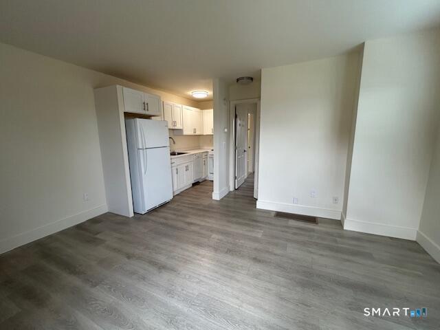 34 Prospect Street, Unit 4M Norwalk, CT 06850 - Photo 7 of 7 a view of a kitchen with a sink and a refrigerator