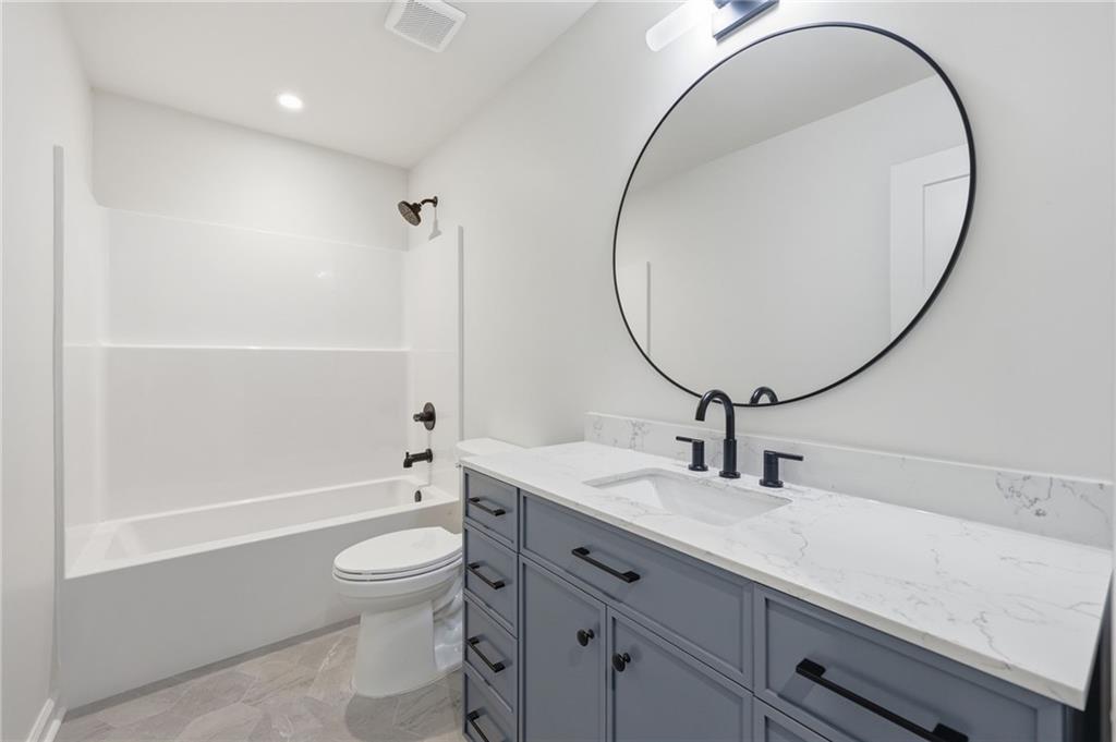 1121 Riverside Terrace Gainesville, GA 30501 - Photo 29 of 39 a bathroom with a sink a toilet and a mirror