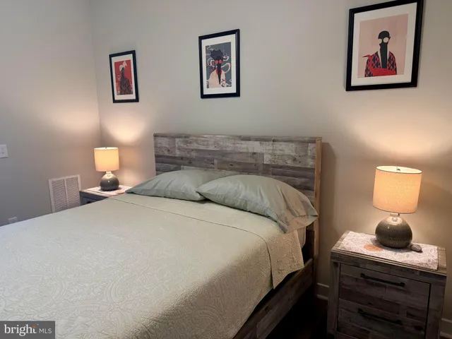 a bedroom with a bed and a lamp on table