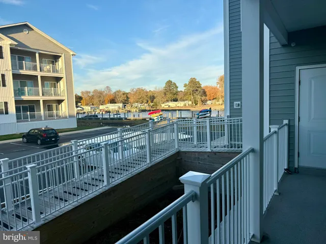 a view of a balcony with wooden floor and fence