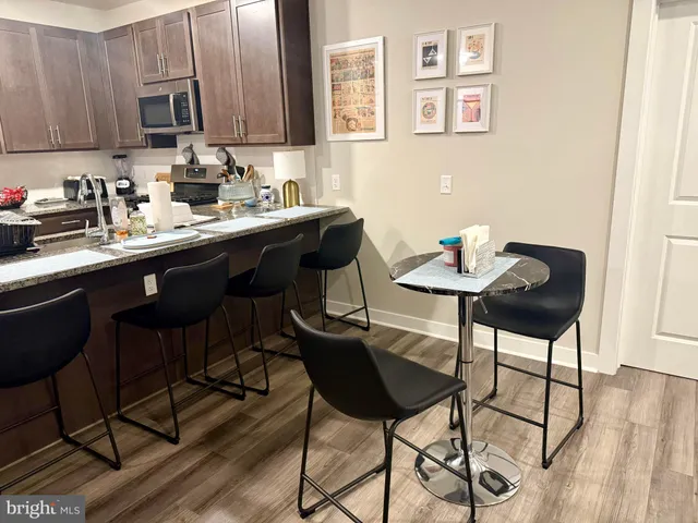 a kitchen with a dining table and chairs