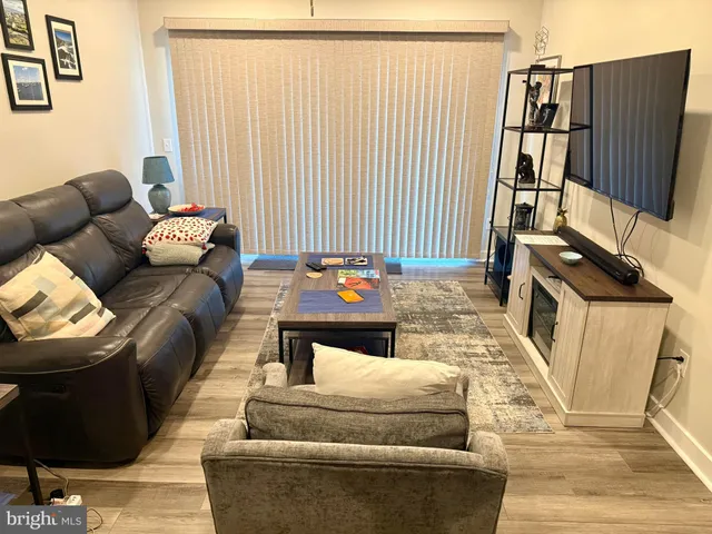 a living room with furniture and a painting on the wall