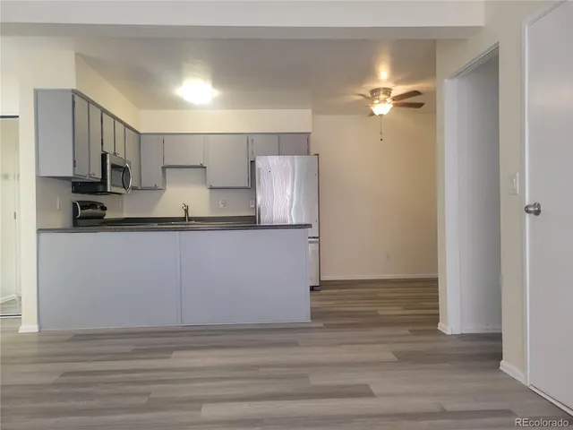 a kitchen with kitchen island a sink stainless steel appliances and cabinets