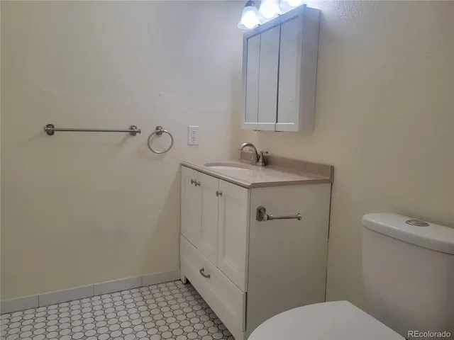 a bathroom with a sink toilet and vanity