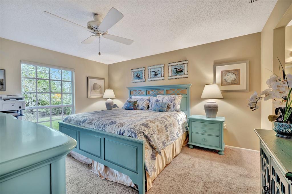 5248 Marsh Field Road, Unit 2 Sarasota, FL 34235 - Photo 11 of 30 a spacious bedroom with a bed a couch and dresser