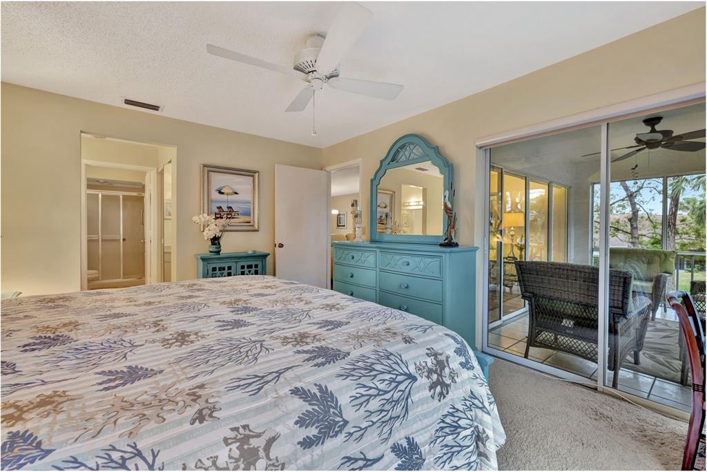 5248 Marsh Field Road, Unit 2 Sarasota, FL 34235 - Photo 13 of 30 a bedroom with a bed and a dresser