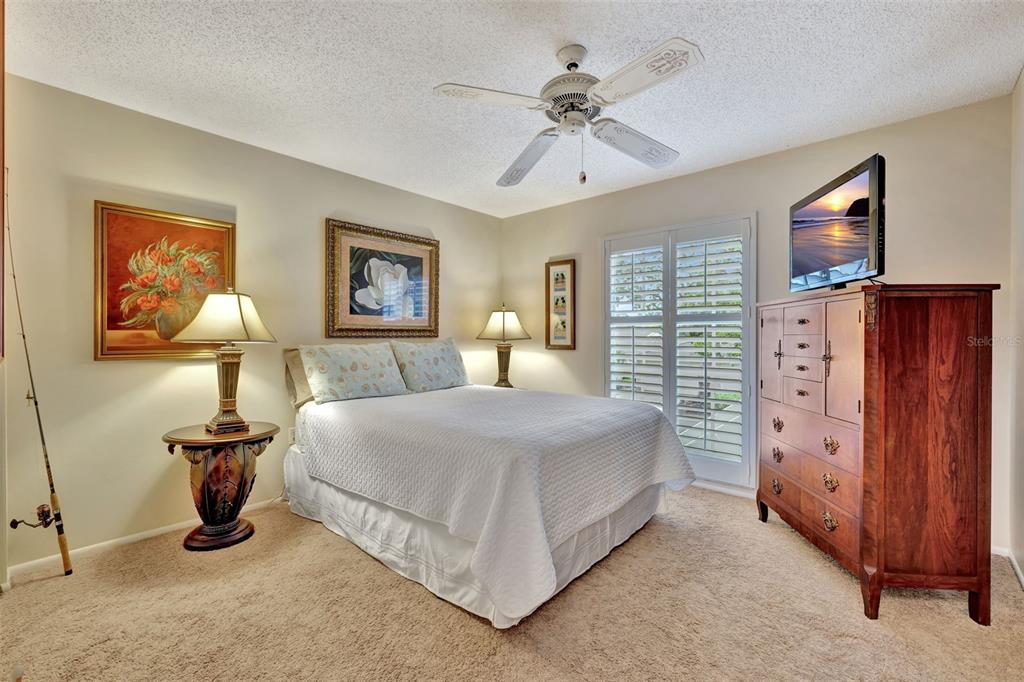 5248 Marsh Field Road, Unit 2 Sarasota, FL 34235 - Photo 17 of 30 a bedroom with a bed and a lamp on dresser