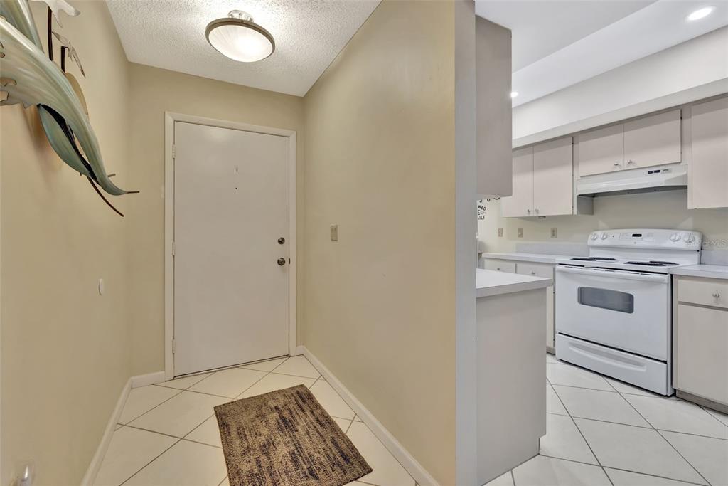 5248 Marsh Field Road, Unit 2 Sarasota, FL 34235 - Photo 18 of 30 a view of a kitchen with white cabinets and white appliances