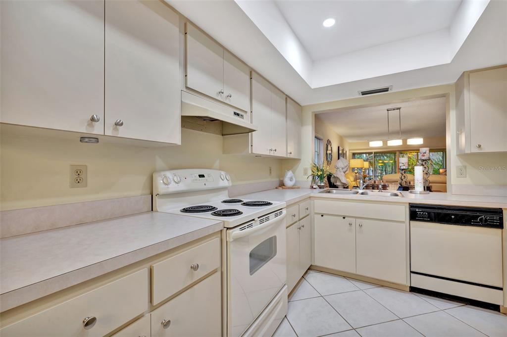 5248 Marsh Field Road, Unit 2 Sarasota, FL 34235 - Photo 23 of 30 a kitchen with cabinets appliances a sink and a counter top space