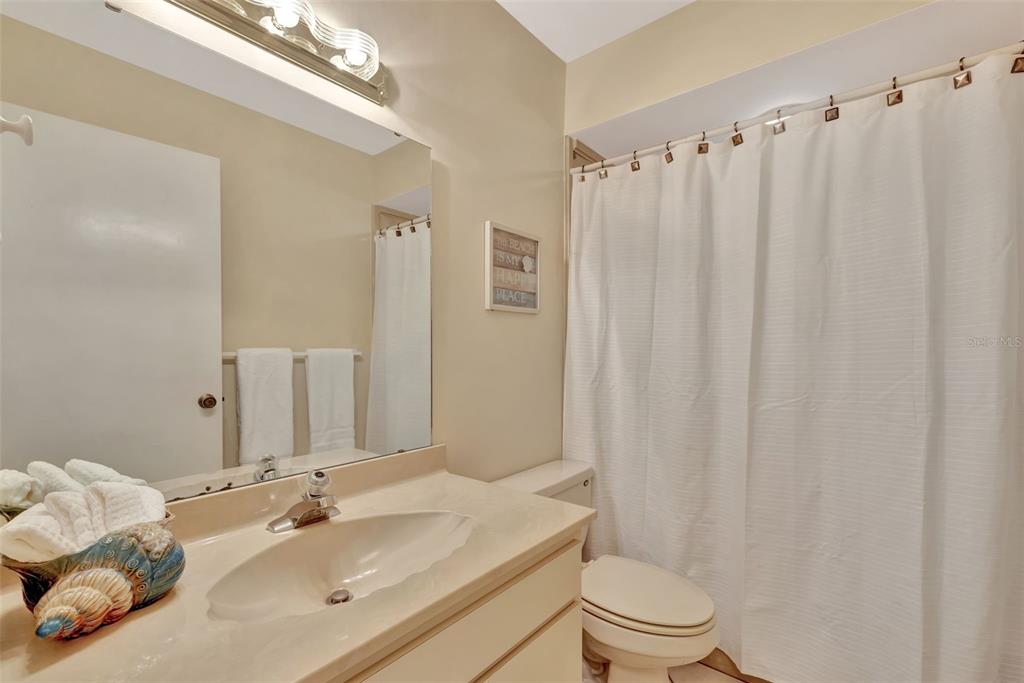 5248 Marsh Field Road, Unit 2 Sarasota, FL 34235 - Photo 24 of 30 a bathroom with a sink toilet and shower