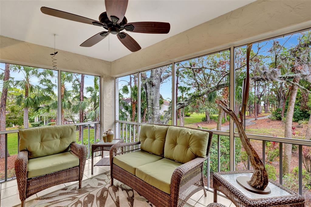 5248 Marsh Field Road, Unit 2 Sarasota, FL 34235 - Photo 27 of 30 a living room with furniture and a floor to ceiling window