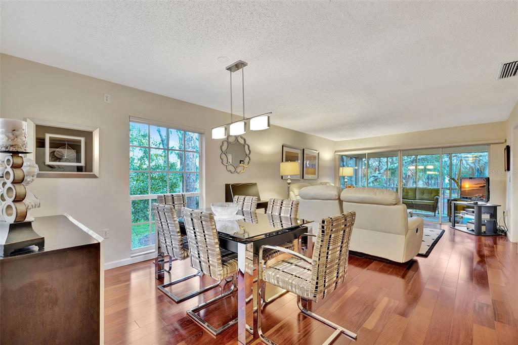 5248 Marsh Field Road, Unit 2 Sarasota, FL 34235 - Photo 5 of 30 a view of a dining room with furniture window and wooden floor